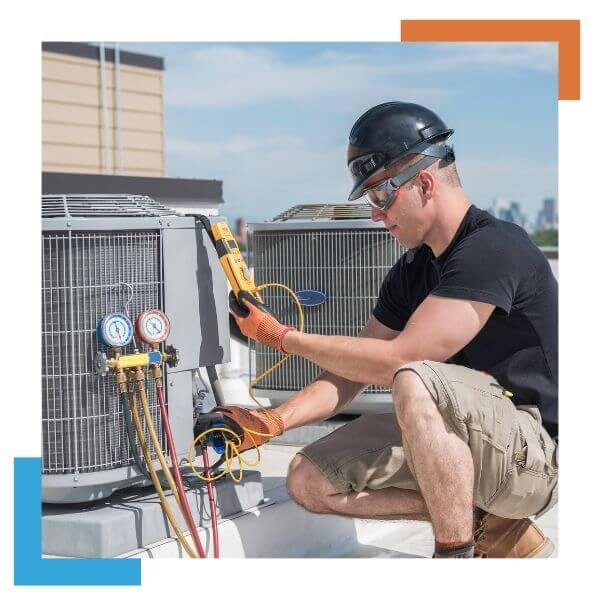 HVAC tech working on an AC condenser 