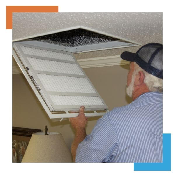 HVAC tech looking in air exchange